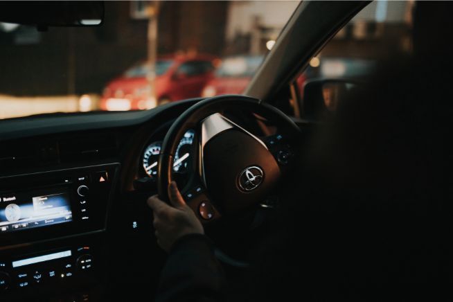 Person driving a car at night