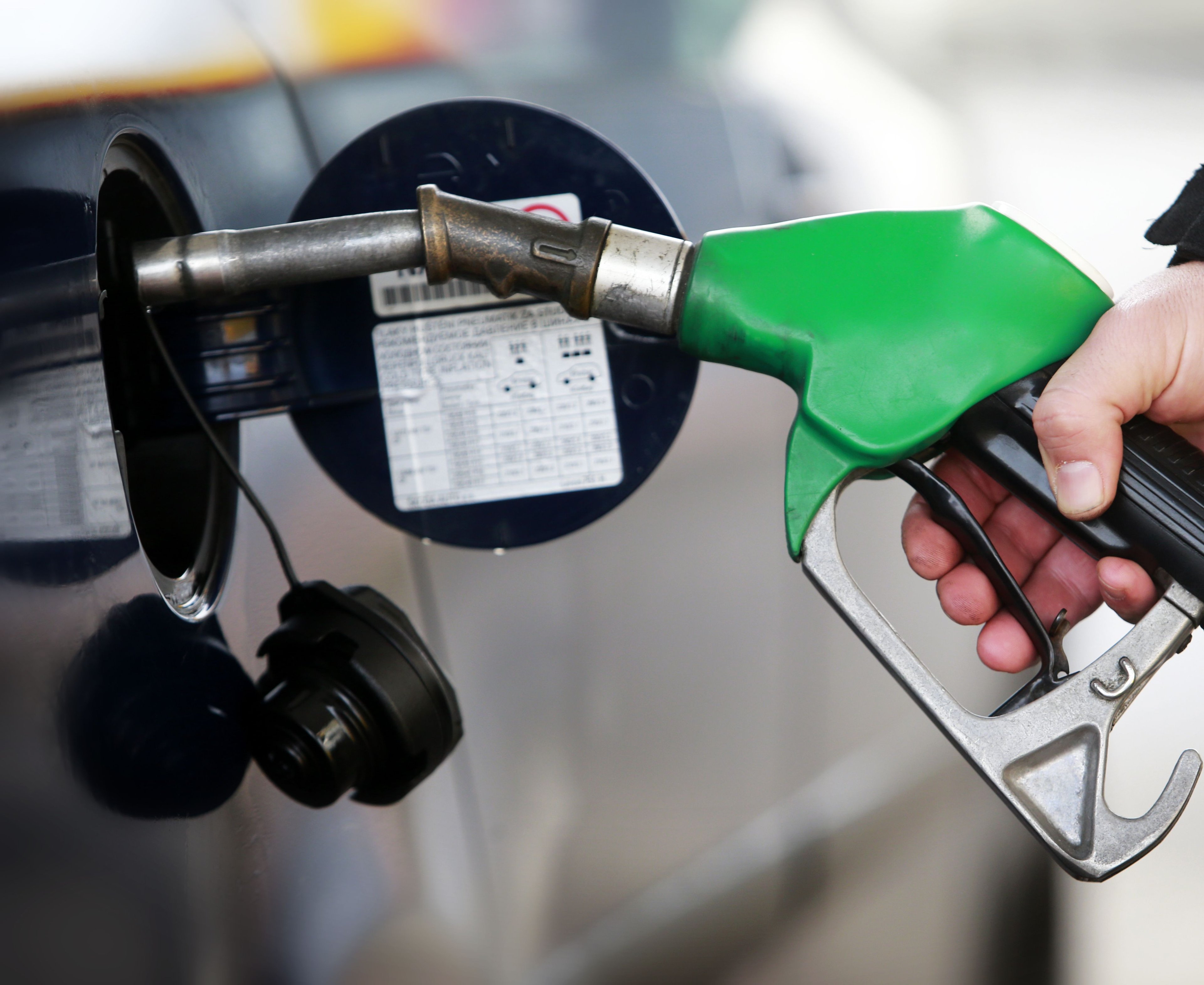 Petrol pump being used at petrol station